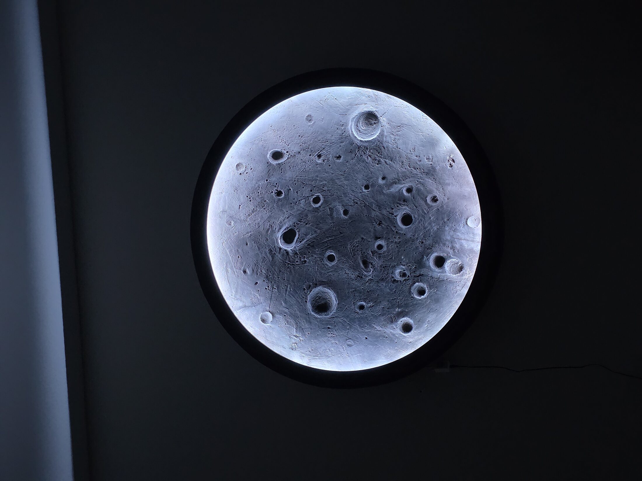 Custom illuminated moon feature with a realistic crater surface
