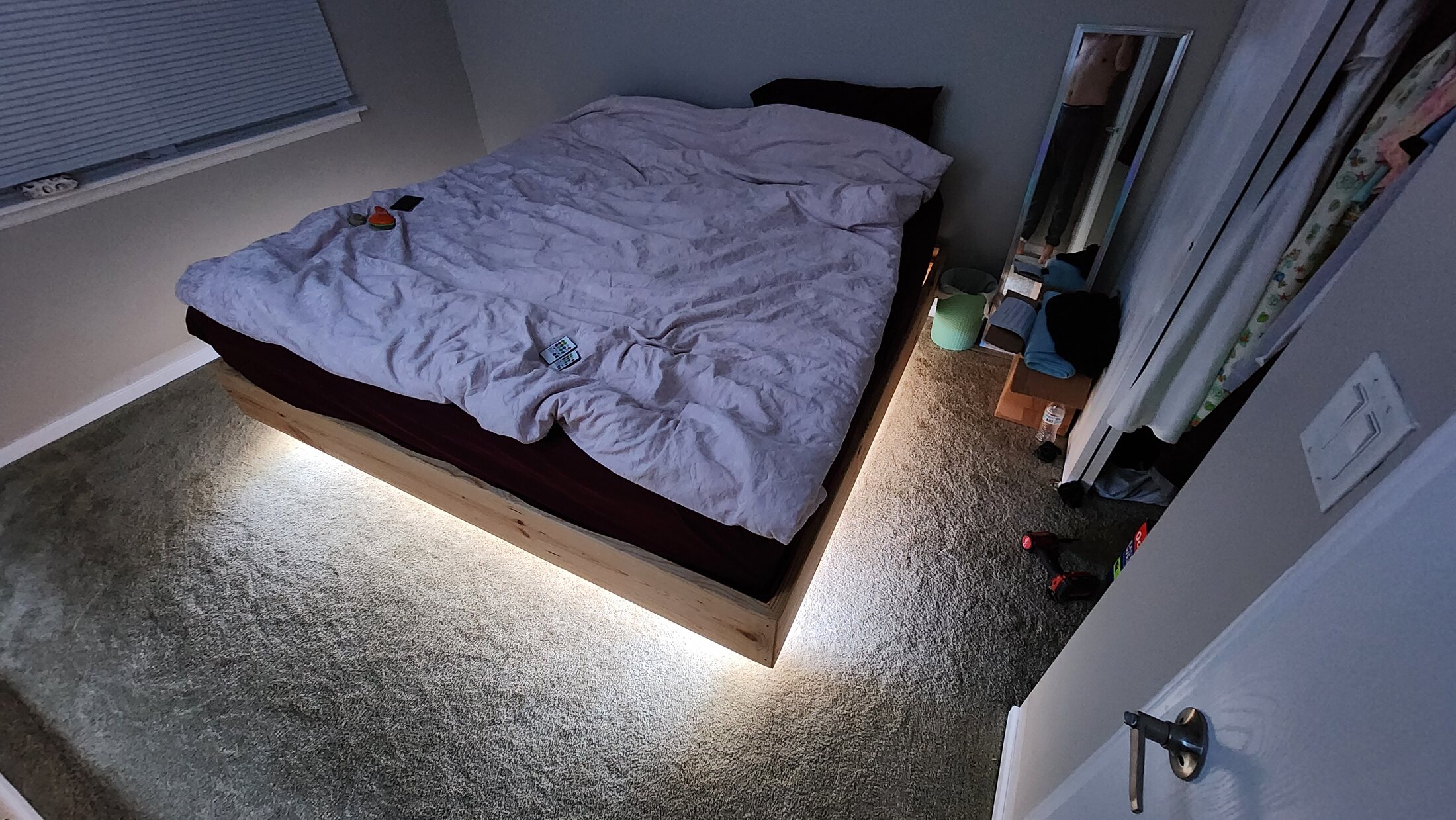 Illuminated moon feature installed above a bed