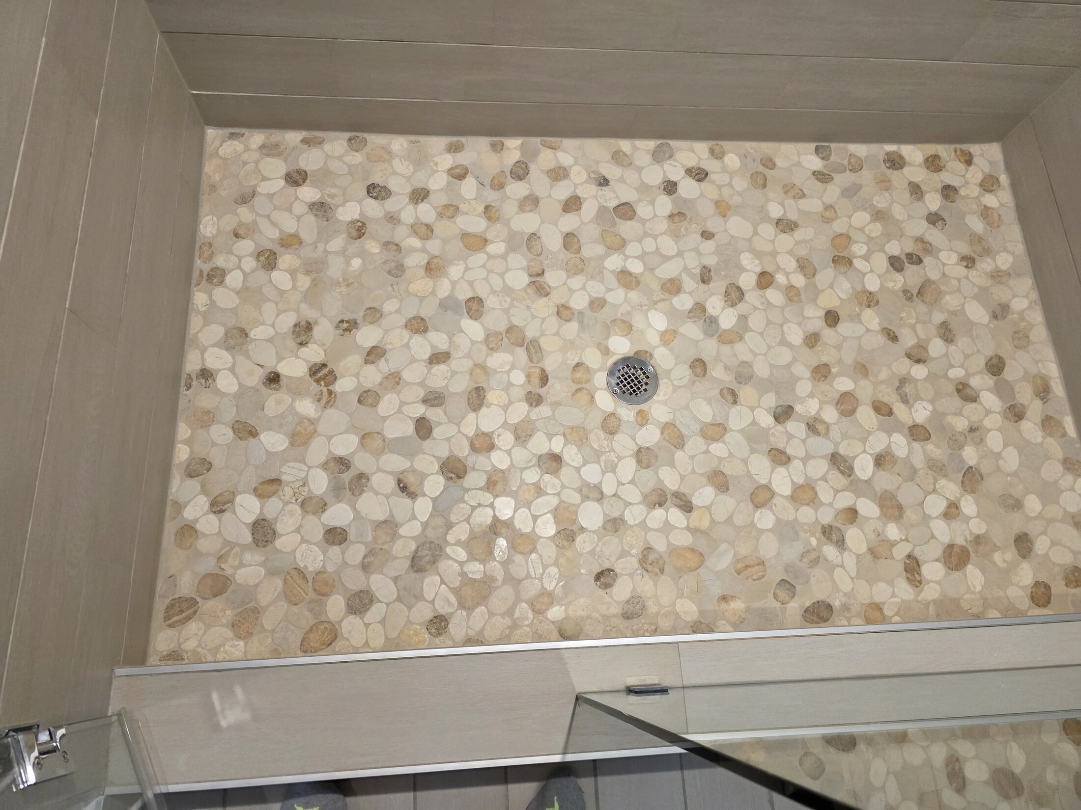 River-stone shower floor with centered drain