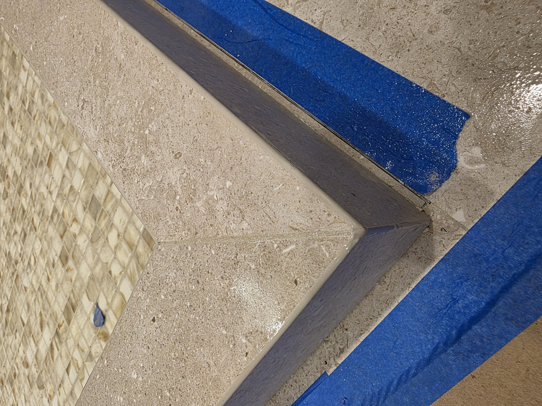 Mitered shower transition with mosaic detail