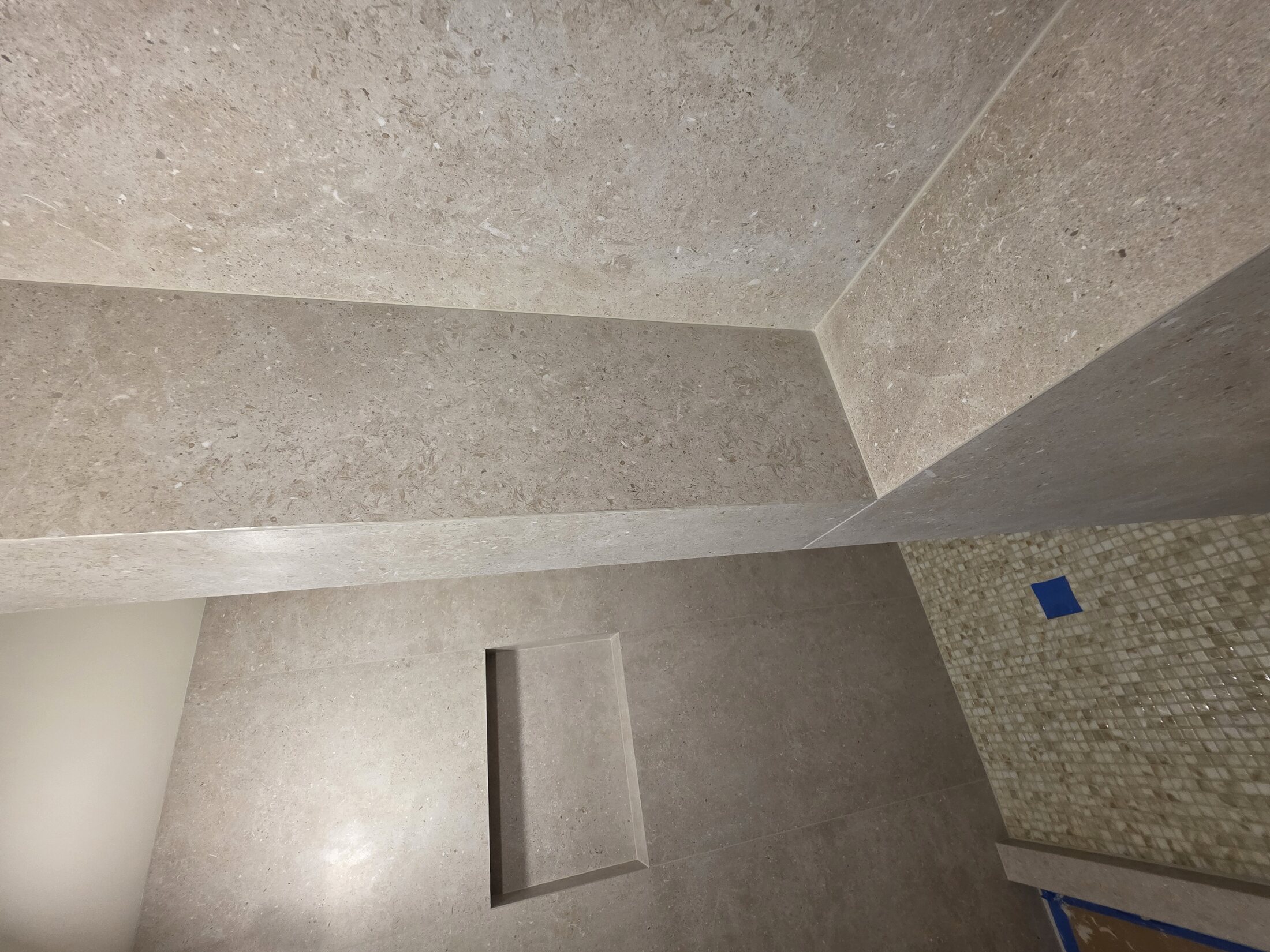 Shower floor, bench, and mosaic transition detail